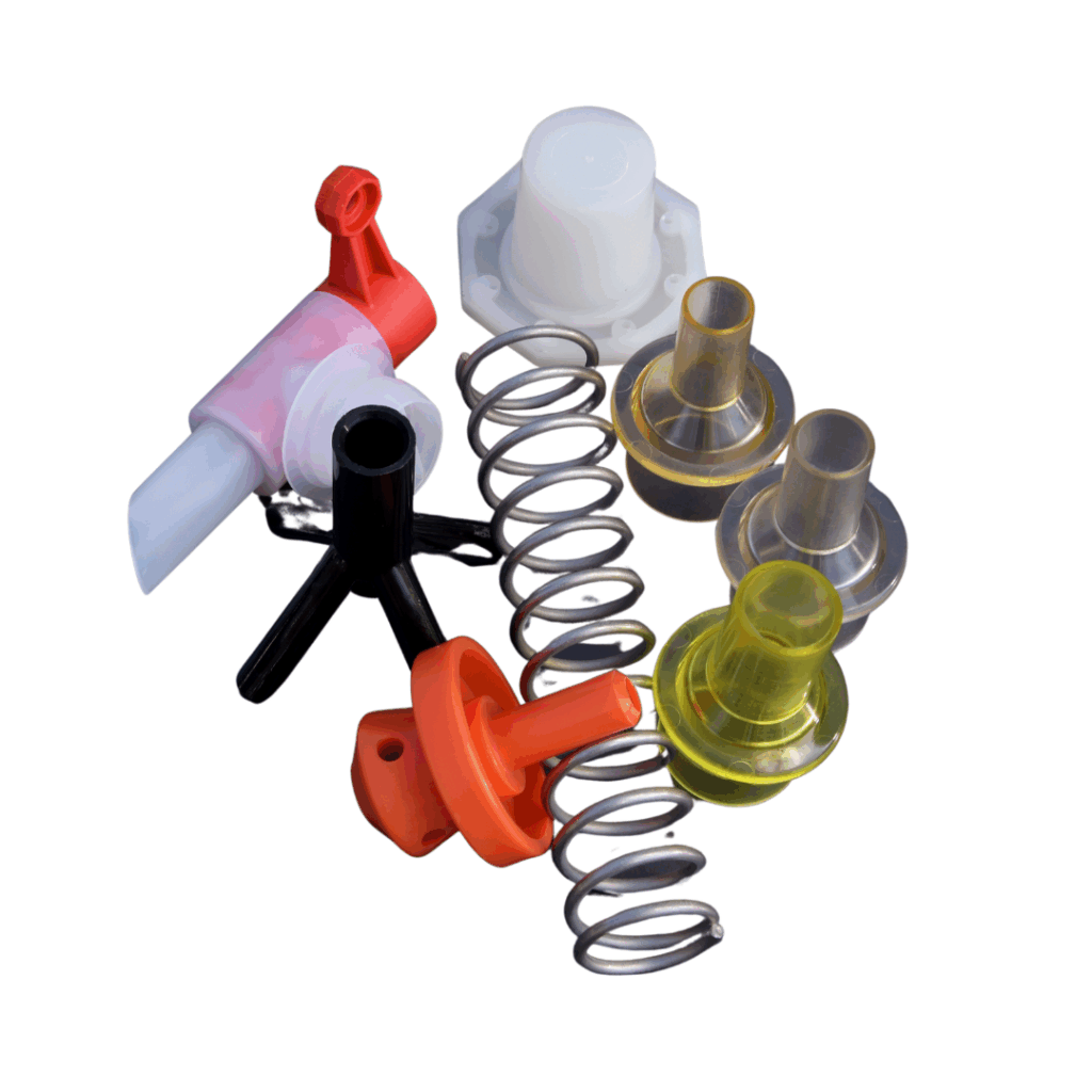 Assorted dairy farming equipment accessories including silicone reducers, plastic fittings, and metal springs, arranged together on a white background.