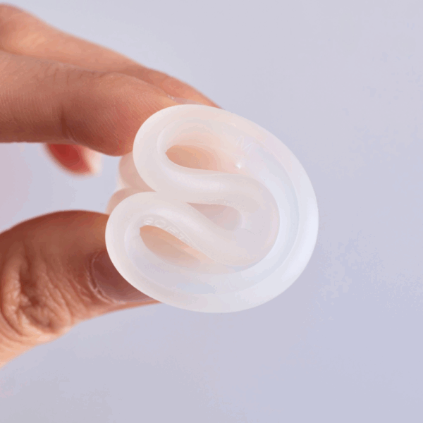 A silicone ring being squashed by a hand