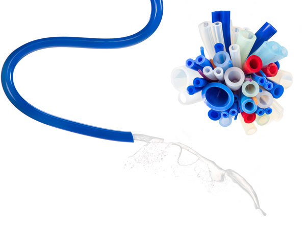 A variety of colourful silicone tubing samples with liquid flowing through a blue tube — showcasing the versatility of silicone products for fluid transfer applications available from Silclear.